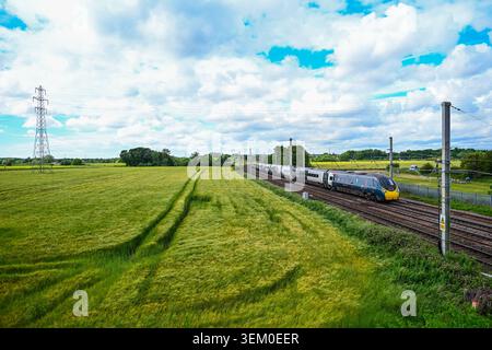 Warrington, UK. 04th June, 2026. A Avanti West Coast British Rail Class 390 Pendolino (390148) during the 9M56 Edinburgh to London Euston service heading south along the West Coast Main Line (WCML) just south of Winwick Junction in Warrington. Credit: Olly Hassell/Alamy Live News Stock Photo