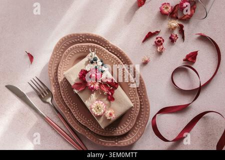 Process of decorating festive autumn table setting with dried flowers Stock Photo