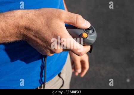 Close-up of a hand holding a compact drone controller Stock Photo