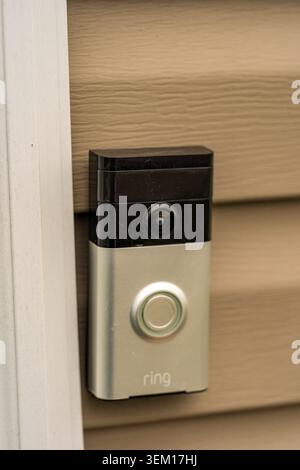 New Holland, PA, USA – March 22, 2022: A Ring doorbell is mounted on the side of a house. The doorbell features a camera and a button for visitors to Stock Photo