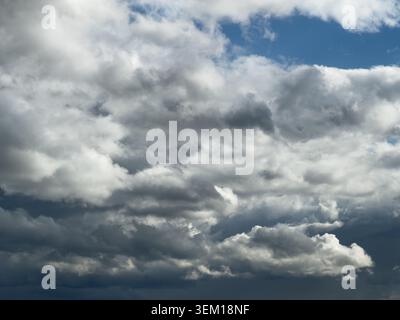 Towering cumulus clouds and dark storm clouds over Yorkshire, England, UK, with patches of blue sky and dramatic summer weather conditions Stock Photo