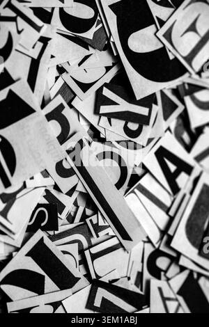 Pile of many black and white letters from newspapers and magazines. Typography background composition. Stock Photo