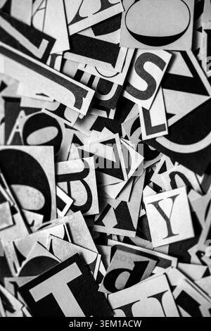 Pile of many black and white letters from newspapers and magazines. Typography background composition. Stock Photo