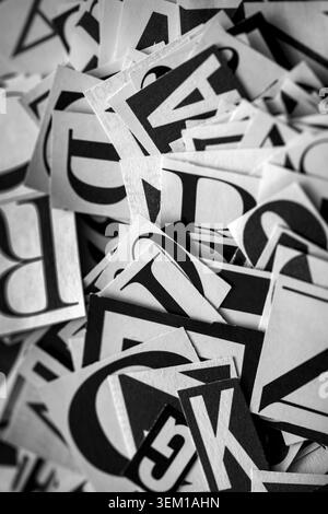 Pile of many black and white letters from newspapers and magazines. Typography background composition. Stock Photo