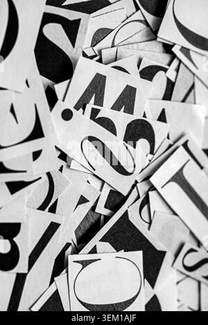 Pile of many black and white letters from newspapers and magazines. Typography background composition. Stock Photo