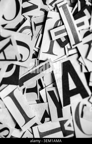 Pile of many black and white letters from newspapers and magazines. Typography background composition. Stock Photo