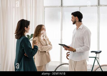Business colleagues collaborating during office meeting discussing ideas Stock Photo