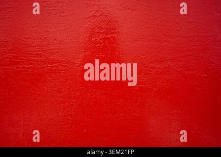 Rough metallic surface painted red. Stock Photo