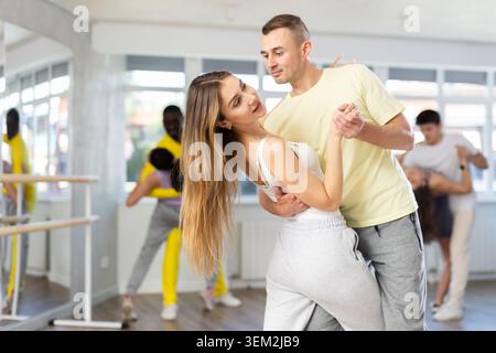 Woman practicing passionate samba with man in dance class Stock Photo