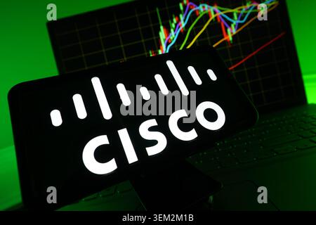 Cisco Systems Logo Displayed On A Modern Screen With A Live Stock Chart Graph In The Background Stock Photo