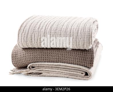 Stack of different cozy blankets isolated on white background Stock Photo