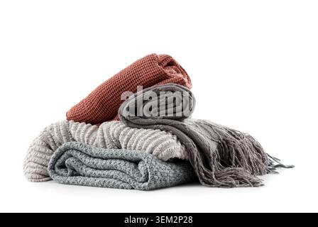 Stack of different knitted blankets isolated on white background Stock Photo