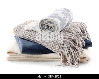 Stack of different soft blankets isolated on white background Stock Photo