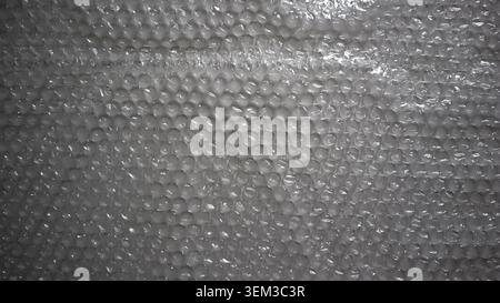Detailed, glossy bubble wrap texture. Full frame background for the protection and packaging of fragile goods. Excellent for logistics, web design, or Stock Photo