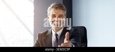 Happy Middle Aged Caucasian Man Greeting, Office Setting, Business Concept Stock Photo