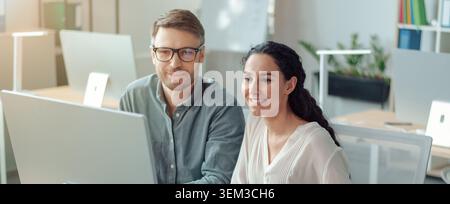 Two Professionals Working Together In Modern Office, Smiling And Engaged, Business Concept Stock Photo