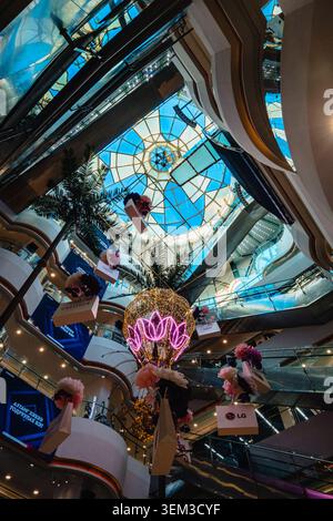 Interior of the State Department Store in Ulaanbaatar, Mongolia, featuring a glass atrium, escalators and modern retail architecture. Stock Photo