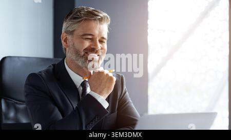 Smiling Middle Aged Caucasian Man Working On Laptop In Office, Business Concept Stock Photo