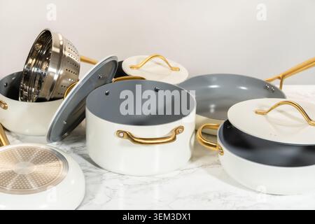Cookware Set Displayed on Marble Surface Stock Photo