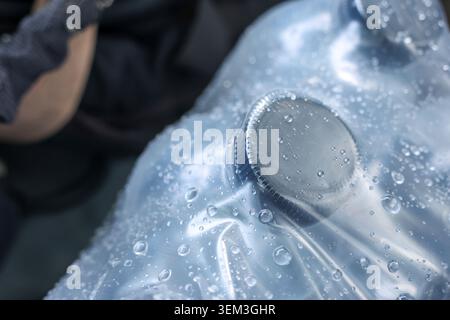 Close up shot of wet blue plastic water bottle covered in fresh condensation droplet, showing cool refreshing feeling, perfect representation of pure Stock Photo