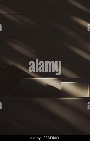 Dark minimalist room with diagonal sunlight and soft shadows on wall and steps Stock Photo