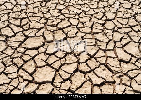 Natural cracked earth texture with desiccation pattern. Stock Photo