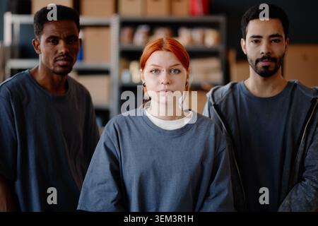 Portrait of Diverse Adult Aid Workers Standing in Relief Center Stock Photo