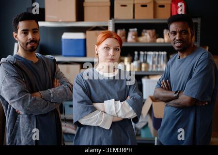 Portrait of Diverse Adult Volunteers Standing in Aid Center Stock Photo