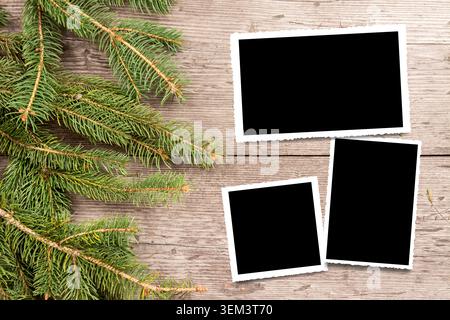 Christmas background with decorations and gift boxes on wooden board, three empty photo frames for your pictures Stock Photo