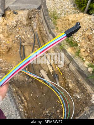 Installation of fiber optic internet cables in urban street infrastructure Stock Photo