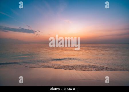 Minimal pastel seascape with subtle warm dusk gradient sky. Calm smooth tropical ocean water. Peaceful wellness background copy space design Stock Photo