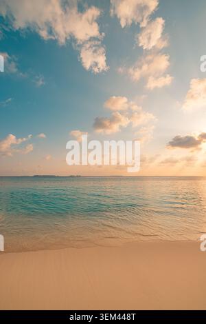 Soft pastel sunset sky over calm tropical sea. Minimal light clouds gentle glow horizon. Peaceful evening ocean seascape background copy space design Stock Photo
