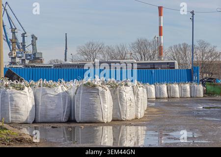 Broken Glass Bottles in White Sacks Material for Recycling Facility Stock Photo