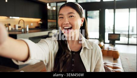 Laugh, selfie and portrait of Asian woman in home for social media, online post and profile picture. Happy, influencer and person with photograph for Stock Photo