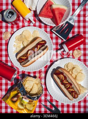 Summer picnic flat lay with hot dogs and watermelon on sunny day. Stock Photo
