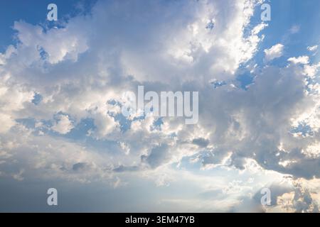 Blue sky white fluffy clouds soft sunlight bright peaceful summer daytime cloudscape view. Nature sky background landscape. Wallpaper backdrop wallart Stock Photo