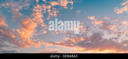 Breathtaking wide sunset sky panorama pastel pink clouds sunrays above horizon. Evening summer cloudscape landscape. Backdrop wallpaper design scenic Stock Photo