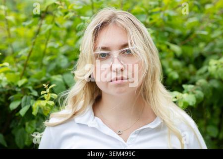 Scientist female with blonde hair outside in a green area Stock Photo