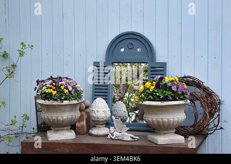 Spring garden display of potted flowers and wicker baskets on a Stock Photo
