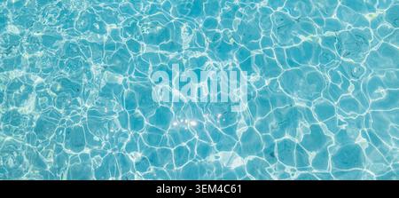 Crystal clear pool water ripples bright daylight. Sparkling aqua surface abstract pattern. Clean turquoise texture refreshing cool backdrop Stock Photo