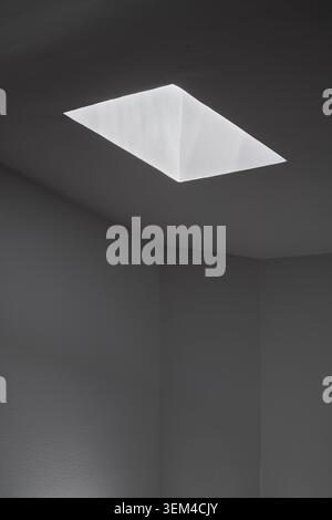 Light entering through the skylight of a house creating an abstract scene of light and shadow. Stock Photo