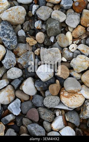 Close up of landscape river rocks ground cover with smooth uneven multicolored stones in varied shapes and sizes Stock Photo