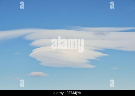 Layered lenticular cloud formation in a clear blue sky over rural Spain. Stock Photo
