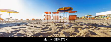 sun loungers on the largest beach in Rimini, Italy. Great Panorama Stock Photo