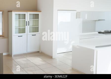 White bookcase with black handles in a room, close-up. Stock Photo