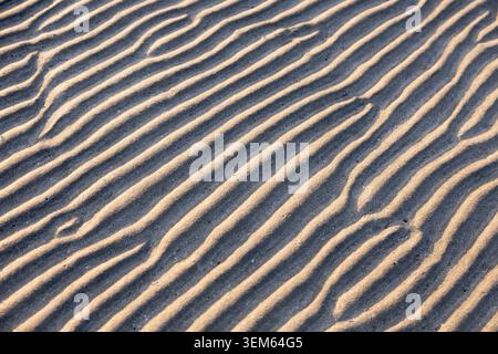 Natural patterns can be seen on the sand during low tide one morning on the beach of Puerto Princesa, Palawan. Stock Photo