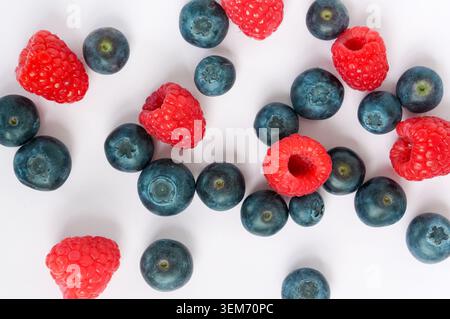 Blueberries and raspberries isolated on white background. Top view. Stock Photo