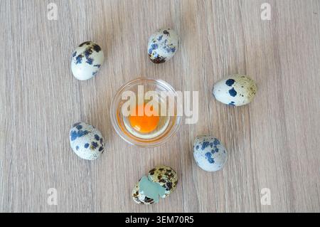 Quail eggs on a wooden background. Quail eggs in a glass bowl. Stock Photo
