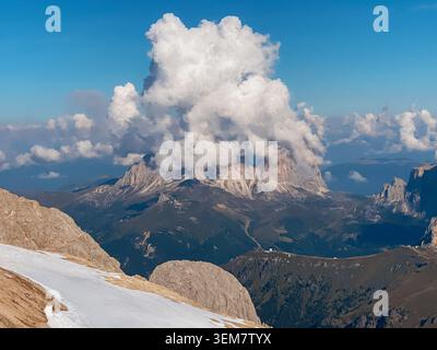 Mountain ridge and dramatic cumulus cloud over alpine valley Stock Photo