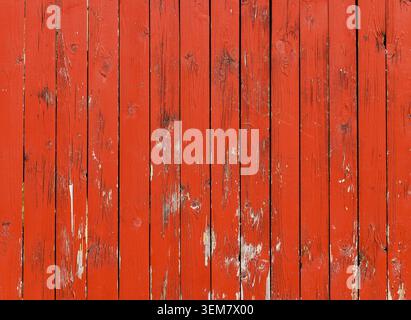 Red painted boards, old wooden fence texture. Narrow planks, background Stock Photo